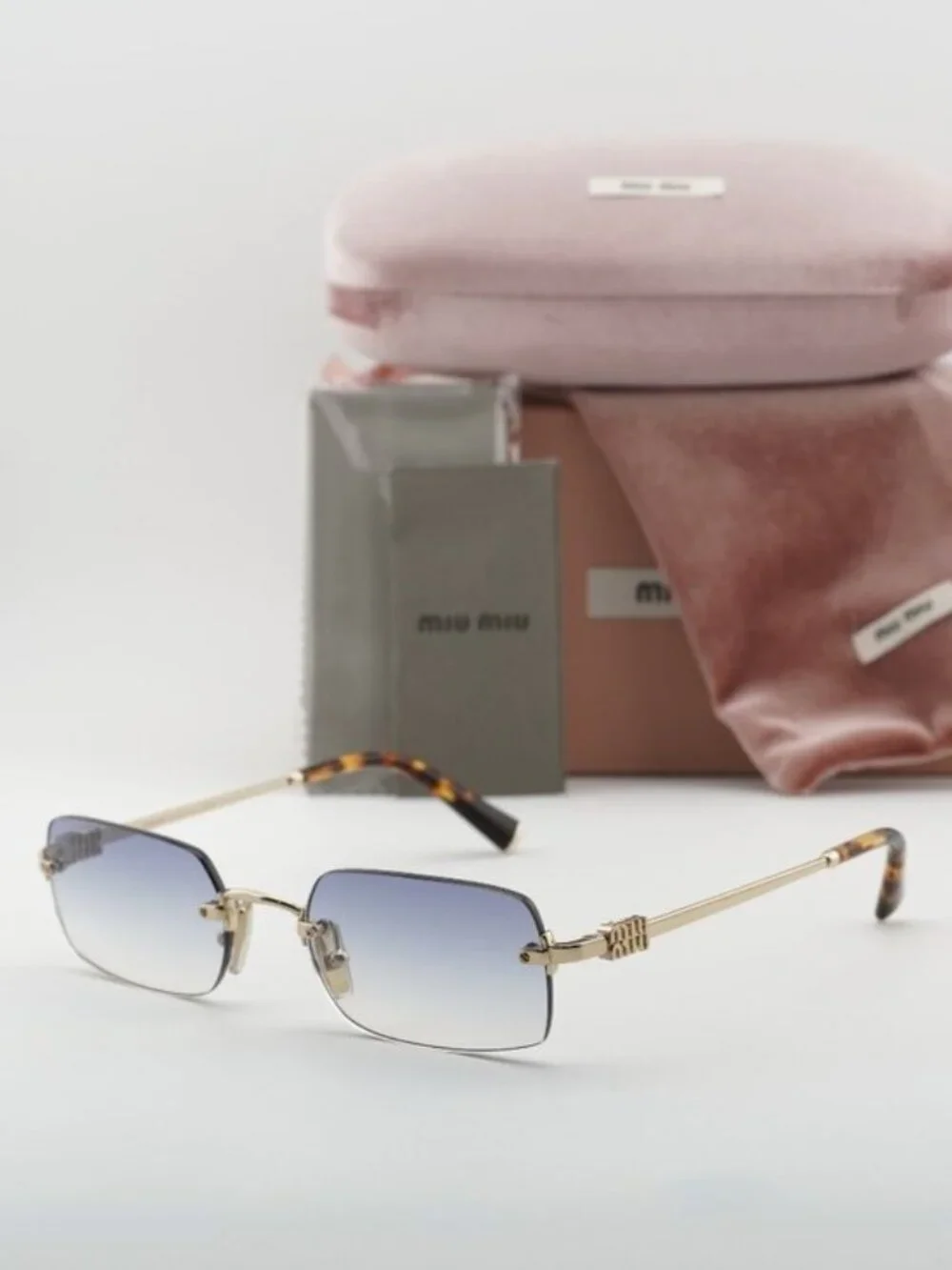 Miu Miu MUB50S ZVN80O Sunglasses Gold Rectangle Frame, Light Blue Lenses